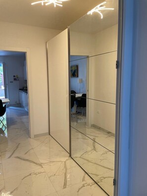 Experience the sleek, modern design of this stylish room, featuring a spacious floor, sliding partition, and contemporary light fixture.
