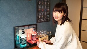 A person standing at a bar with a framed menu and a sign above it. - RetroChaya1 (Osaka)