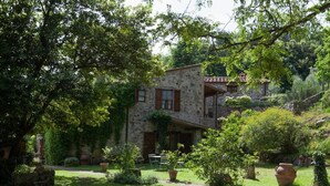 A stone building with a garden, outdoor seating, and a staircase leading to a second level. - beautiful accommodation in a quiet location and with a huge garden, M2 (Pomaia)