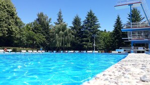 A swimming pool with numbered lanes, a diving platform, and a sign indicating a depth of 1.00m. - Holidayflat with balcony, seperate entrance, near Thuringian Forest (Floh- Seligenthal)