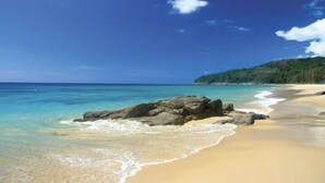 A beach with clear turquoise water, sandy shore, and a rocky outcrop. - Luxurious, quiet, private Pool-Villa Lotus, 7/7 housekeeper/butler (Phuket)