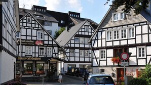 A traditional half-timbered building with a sign for a café and restaurant.