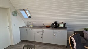 Enjoy cooking in this kitchen with a sink and countertop area, featuring a toaster, coffee maker, and ample storage.