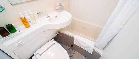 A modern bathroom with a white sink, toilet, and bathtub. There are toiletries on the sink counter.