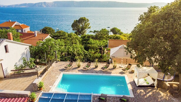 A swimming pool with a view of the sea, surrounded by houses and trees. - New villa for 6 persons with private pool and sea view (Smokvica Krmpotska/Klenovica)