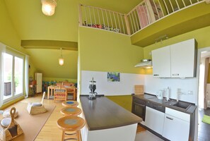 Enjoy meals in the kitchen with a central island, dishwasher, and sink, and dine in the adjacent seating area with a table and chairs.