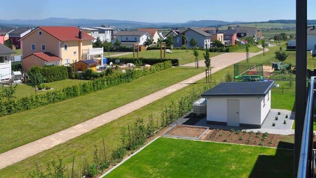 A residential area with houses, a clear sky, and a view of distant hills. - Ambience apartment with terrace - modern-one | Attractive apartment w. (Fulda)