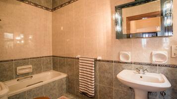 Bathtub, hair dryer, towels, soap
