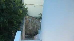 A staircase with stone walls and a white railing, leading to a higher level. - MODERN APARTMAN - 4 TO 6 PERSONS WITH A STUNNING SEA VIEW (TISNO)