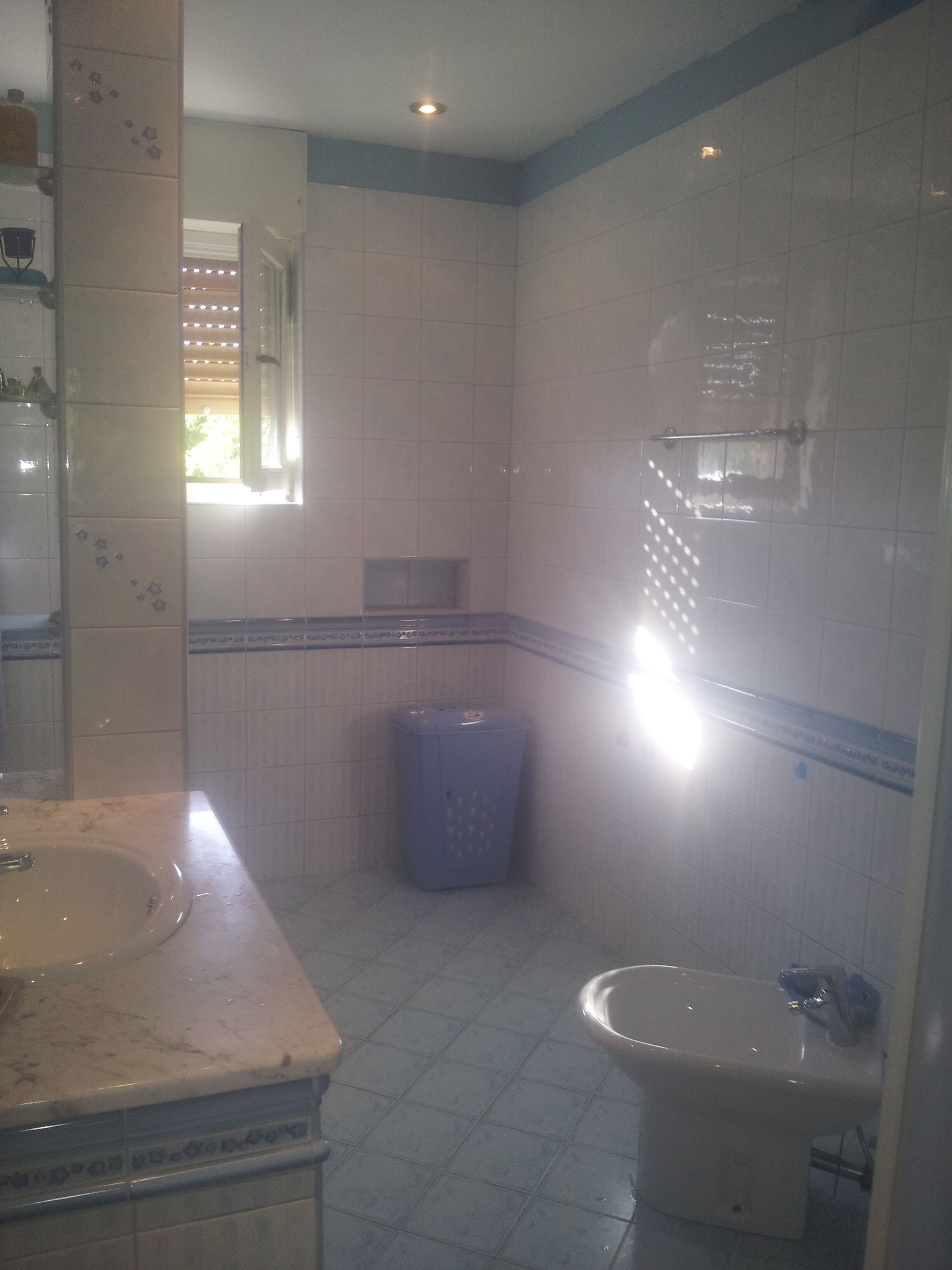 A bathroom with a sink, mirror, and a toilet.