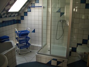 Bathtub, towels, soap, toilet paper