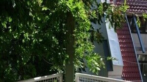 A round metal table with chairs and a lantern, surrounded by a metal fence and greenery. - Idyllic, central, quiet, high-quality apartment in an old building with excellent transport connections (Heidelberg)