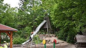 A playground with a slide, swings, and a climbing structure. - Idyllic, central, quiet, high-quality apartment in an old building with excellent transport connections (Heidelberg)