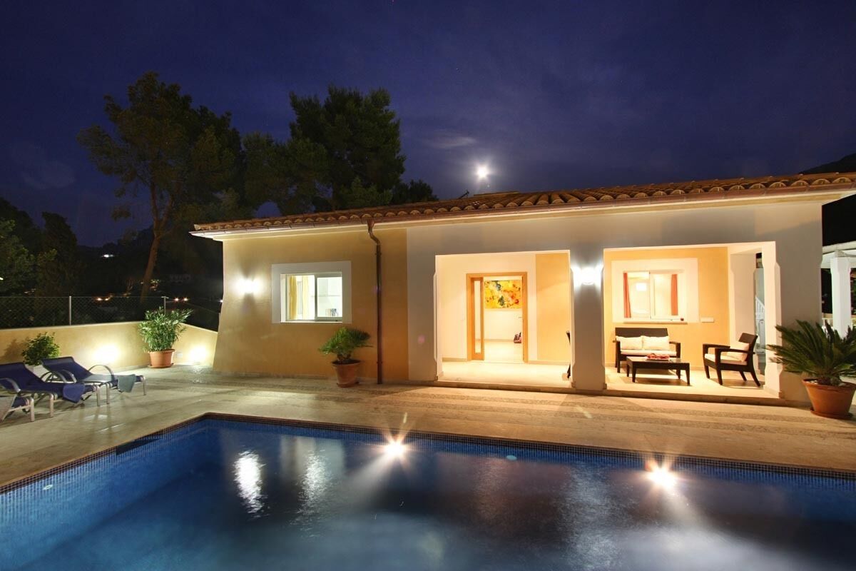 A swimming pool with lounge chairs and a patio area.