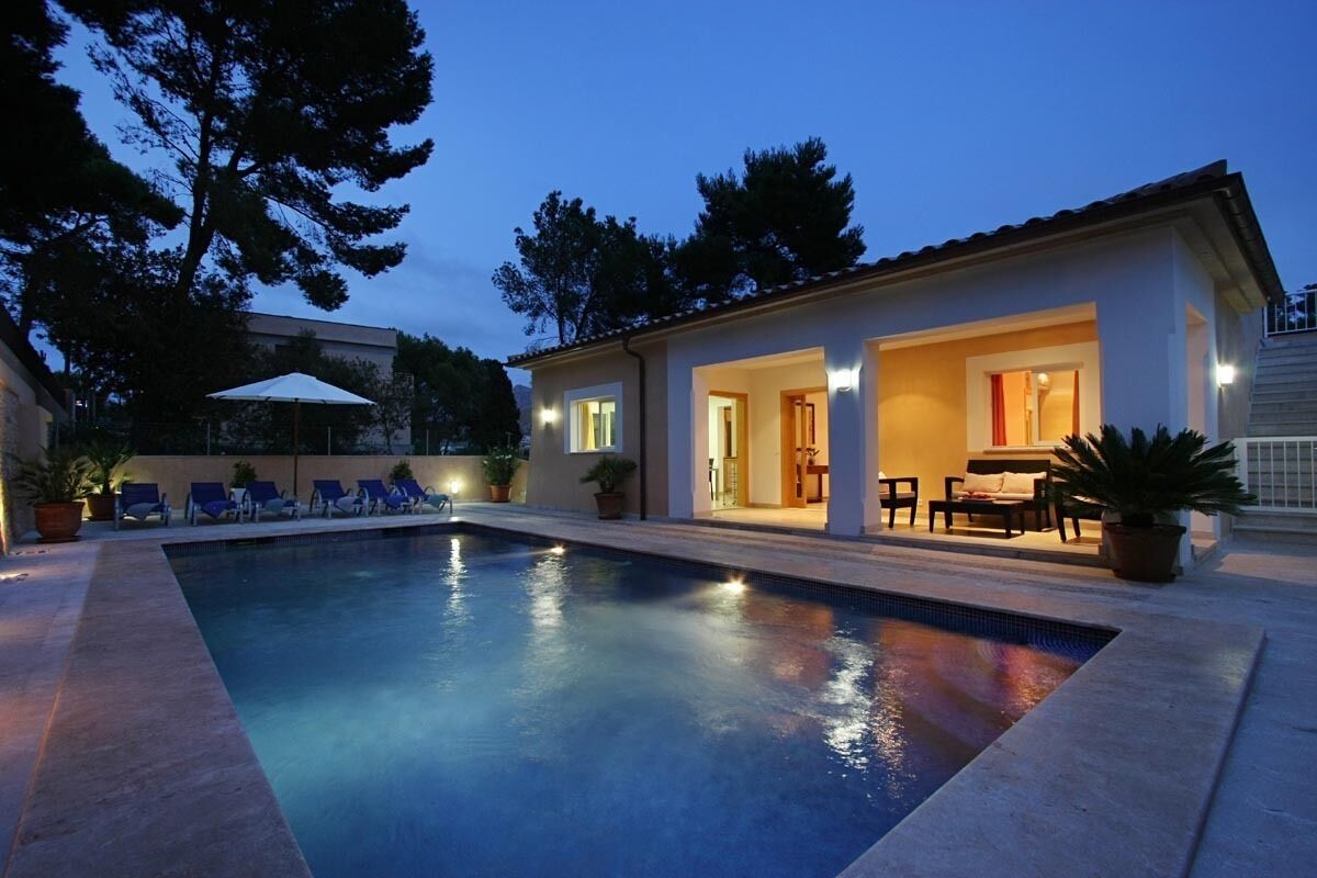 A swimming pool with lounge chairs and a patio area.