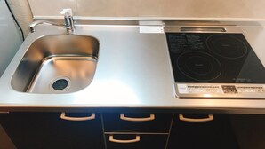 A kitchen with a stainless steel sink and a built-in induction cooktop. - GH One More Heart Enmachi 3 (Kyoto)