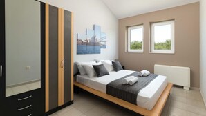 A bedroom with a bed, a wardrobe, a radiator, and a window with a view. - The idyllic oasis of well-being (Soroni)