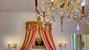 A luxurious bedroom with a large bed, ornate chandelier, and red drapes. - Venetian palazzo near St. Mark's Square & Arsenal, canal view, free Wi-Fi (Venezia)
