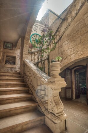 A stone staircase with ornate balustrades leading to a doorway.