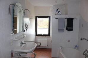 Bathtub, hair dryer, towels, soap