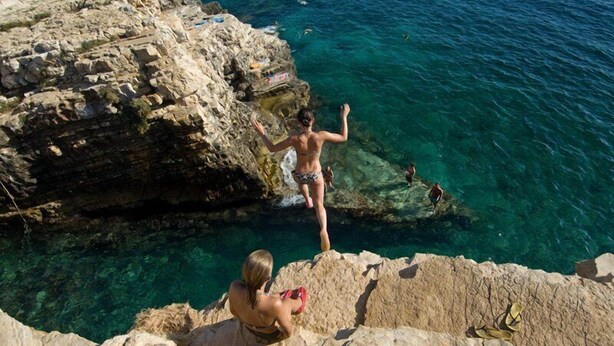 A rocky coastal area with clear blue water.