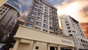 A hotel with a modern architectural design, featuring a prominent entrance and multiple windows. - Brown-dot Hotel Paju Heyri (Paju)