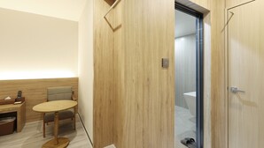 A modern bathroom with a wooden vanity, a round table with chairs, and a glass shower door. - Brown-dot Hotel Paju Heyri (Paju)