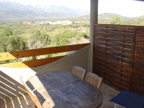 Enjoy an outdoor space with a mountain view from this balcony.