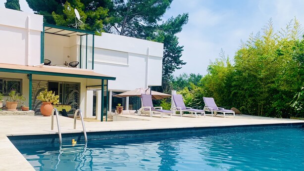 A swimming pool with lounge chairs and potted plants. - The Zen villa, sun and idleness (Pinet)