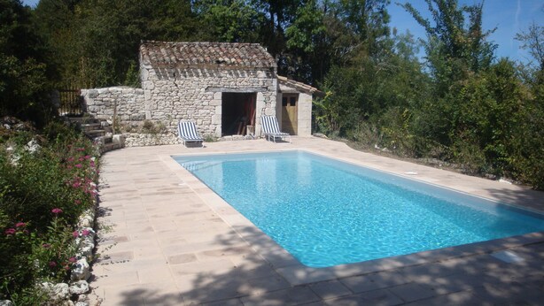 A stone building with a pool, surrounded by trees and a stone pathway. - Beautiful Authentic Stone House In The Lot REDUCED RATE ! (Montcuq-En-Quercy-Blanc)