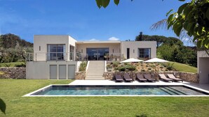 A modern two-story house with a swimming pool, outdoor seating, and a landscaped garden. - Luxury single-storey Villa on French Riviera , View & heated swimming pool (ST PAUL DE VENCE)