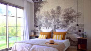 A bedroom with a large window, a bed with striped pillows, and a mural of trees on the wall. - Luxury single-storey Villa on French Riviera , View & heated swimming pool (ST PAUL DE VENCE)