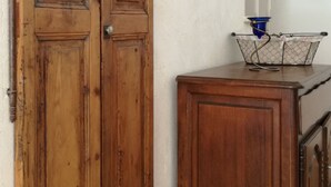 A hallway with wooden doors and a white wall.