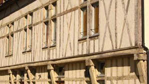 A half-timbered building with multiple windows and a wooden door. - Cottages to Orient - Chalet Nature (Géraudot)