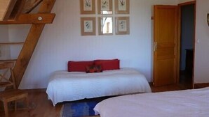A bedroom with a bed, a wooden ladder, and a door. - A quiet and comfortable house in a burgundy's medieval village (Flavigny-Sur-Ozerain)