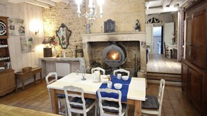 A rustic dining area with a stone wall, wooden furniture, and a fireplace. - Dordogne Valley, 4 * holiday house, exclusive pool, 12kms from Bergerac (Bergerac)