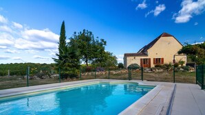 A swimming pool with a clear blue water, surrounded by a stone deck and a fence. - Charming cottage and nature, 18 ha, Périgord Noir-Dordogne -Lot -PISCINE and private SPA (Orliaguet)
