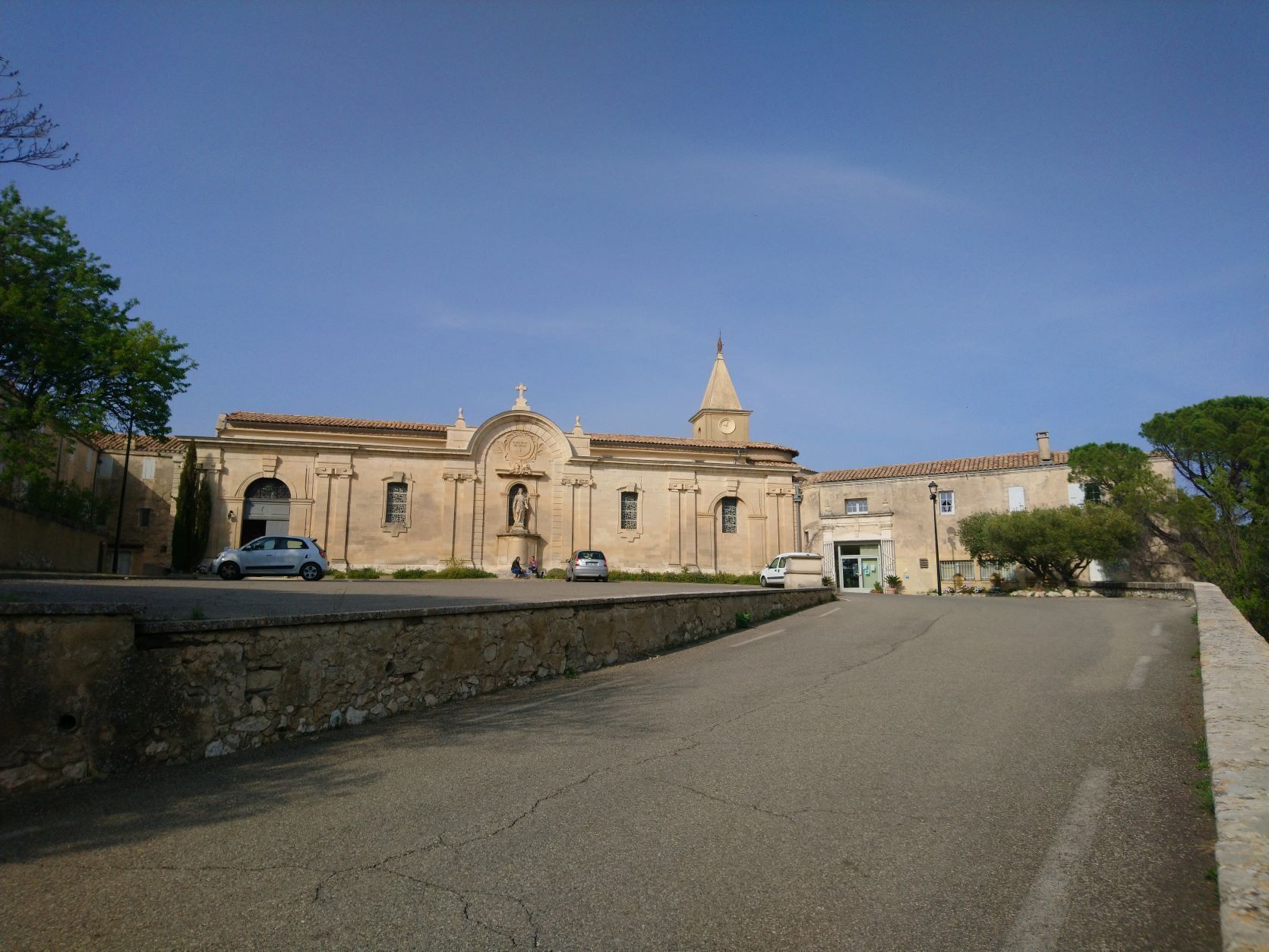 A historic building with a central dome, arched windows, and a bell tower.