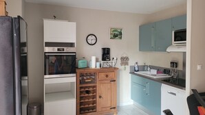A compact kitchen with a microwave, toaster, and coffee maker.