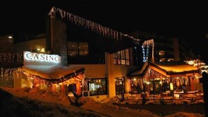 A building with a 'CASINO' sign, featuring a prominent entrance and a large window.