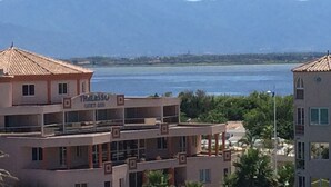 A building with a sign reading "HALASSO CENTRO 350" indicating a hotel or resort. - Apartment facing the SEA and BEACH with view of POND and MOUNTAIN (Canet-En-Roussillon)