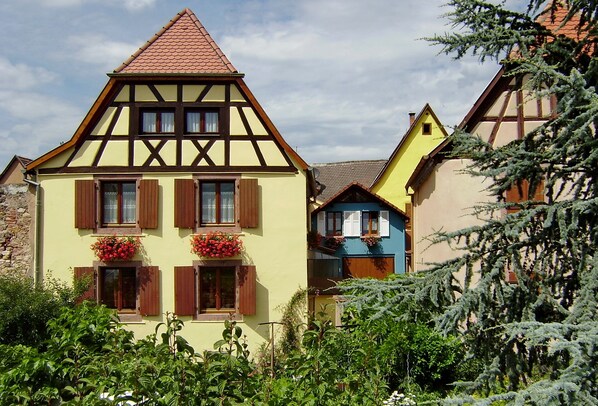 A traditional half-timbered house with a steeply pitched roof and dormer windows.