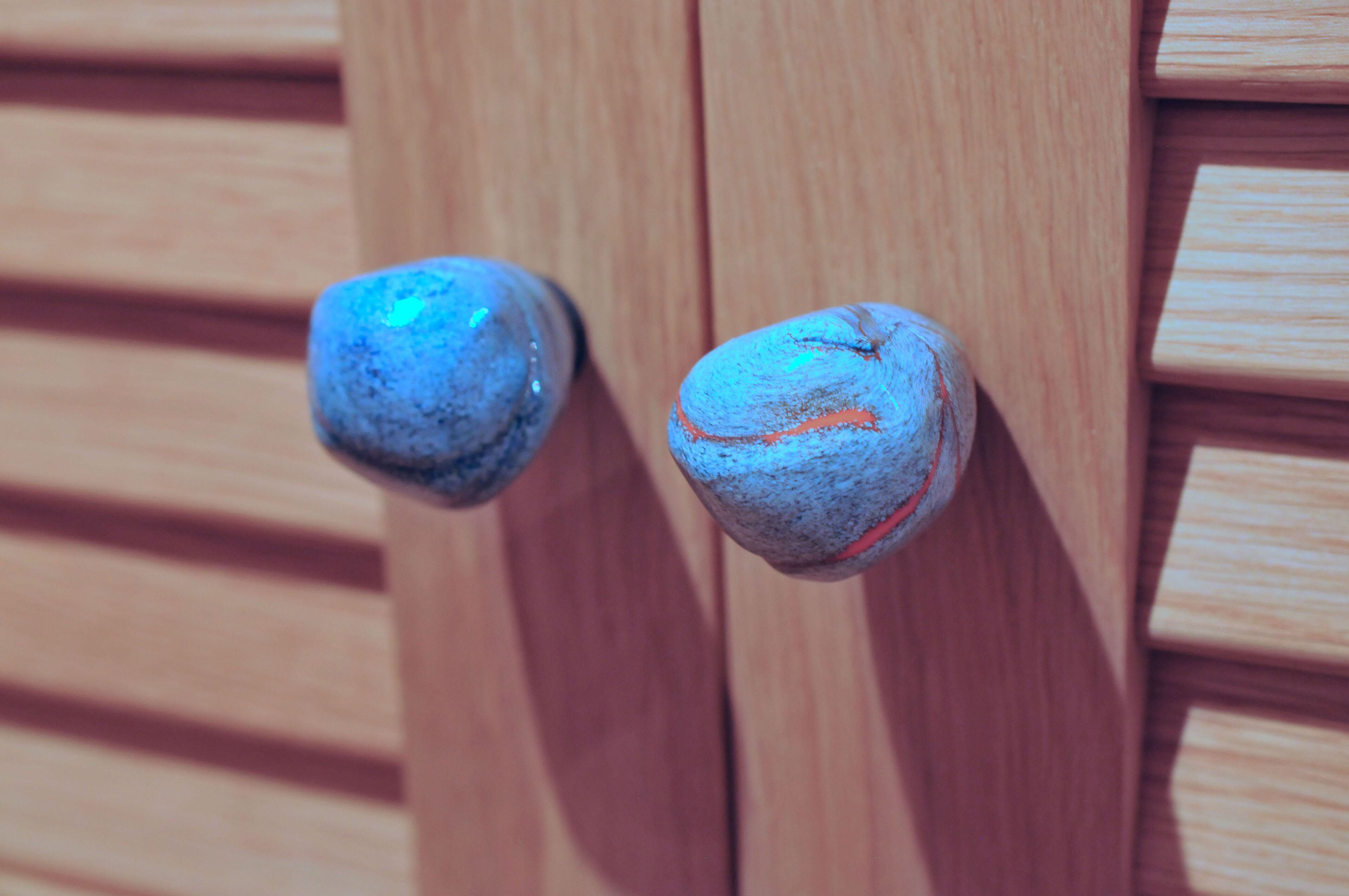 Two wooden door handles.