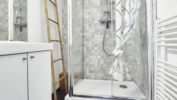 Shower, hair dryer, towels, toilet paper