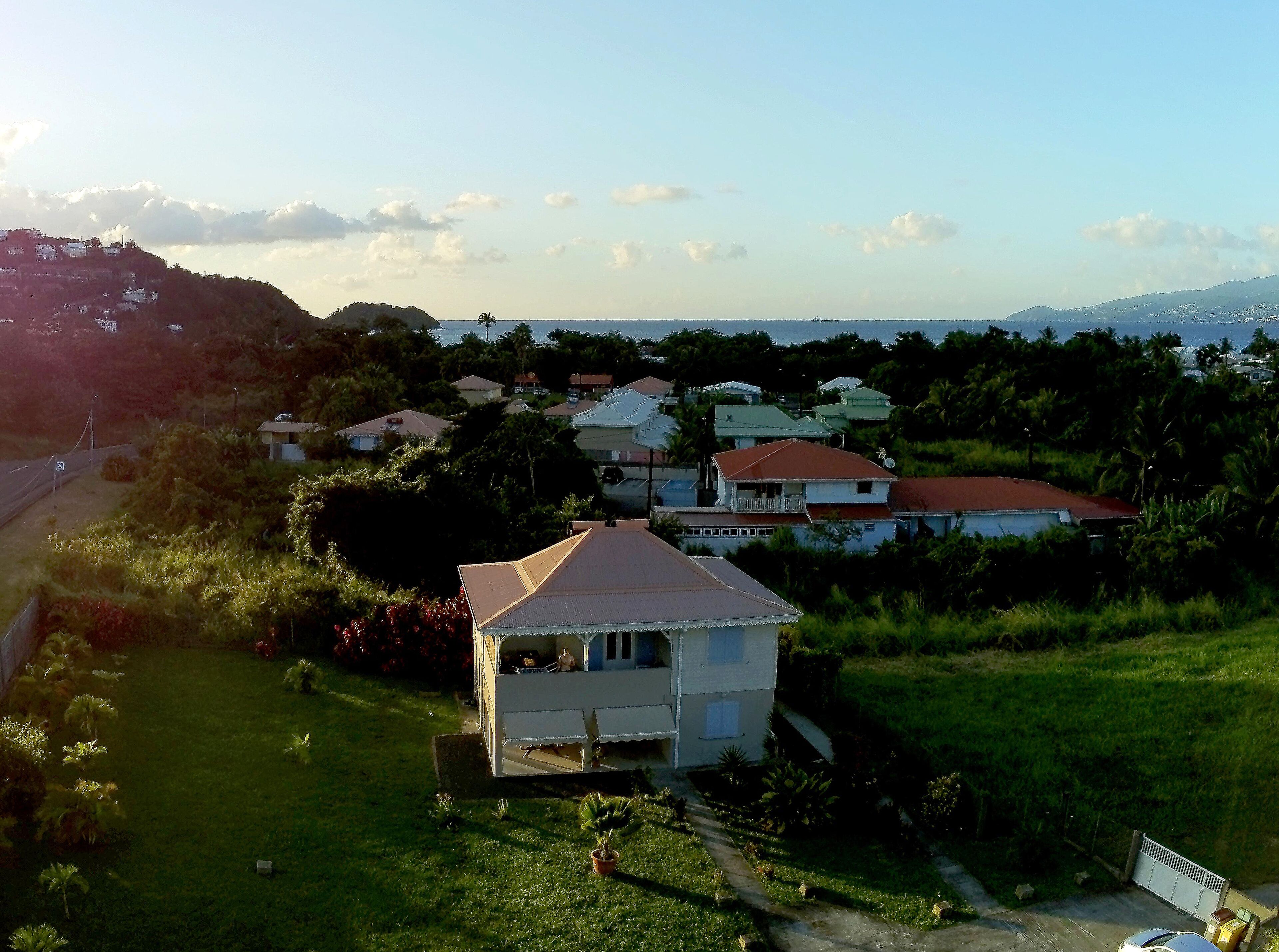 A residential area with houses, a grassy area, and a road.