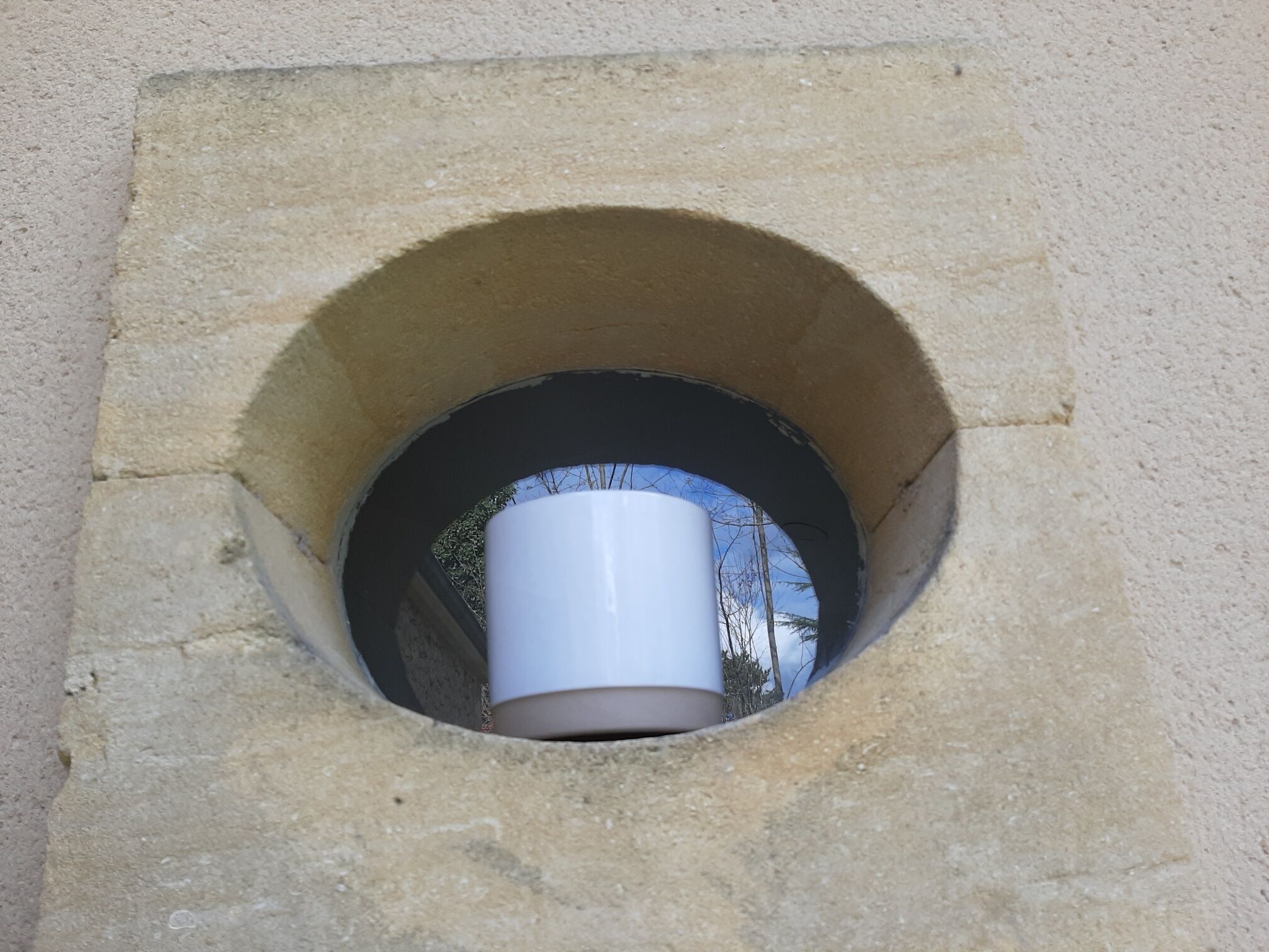 A stone structure with a circular opening.