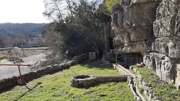 Een natuurlandschap met een reeks van stenen vijvers en een rotsachtige klif.