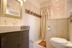 Bathtub, hair dryer, towels, soap