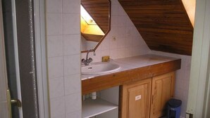 A small, compact kitchen with a wooden countertop, a sink, and cabinets. - large capacity village house (LARUNS)