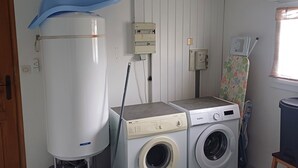 A laundry room with a washing machine, dryer, and a water heater.